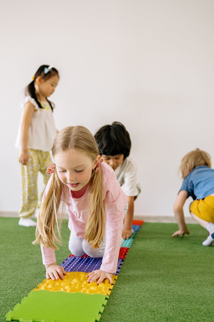 children playing with colorful mats